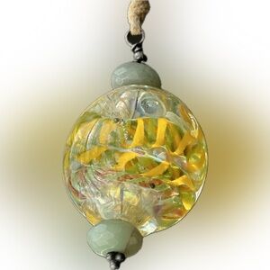 Glass Pendant with Swirling Gold and Green Design